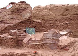 Masonry Wall Excavation of a wall in red rock.