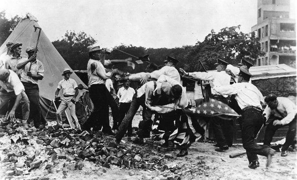 Police and protestors fight with clubs.