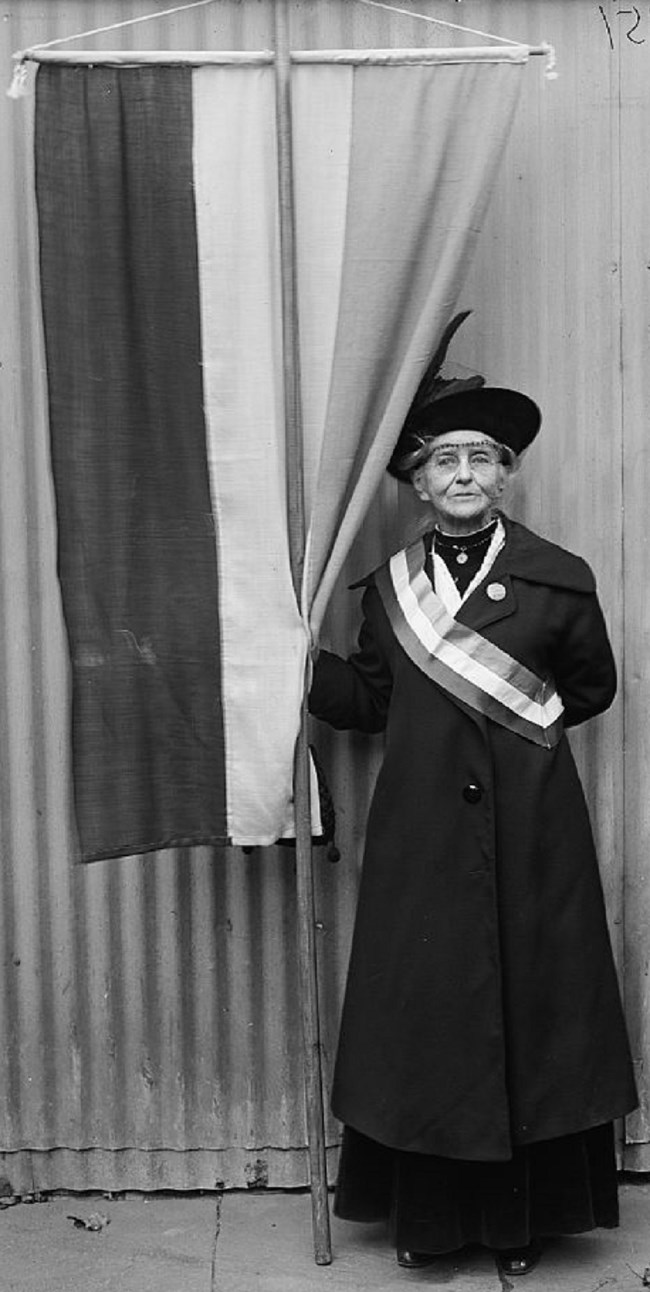 Woman suffragist holding NWP banner. Library of Congress.