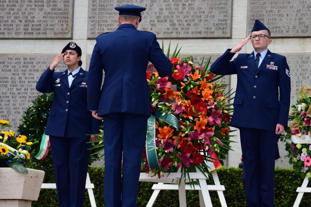 Soldiers saluting at a wreath laying ceremony