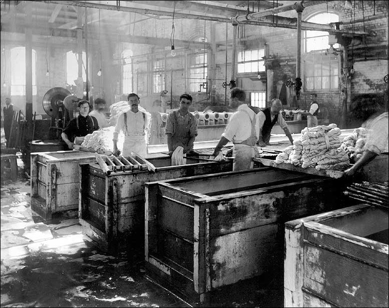 Several men standing and working.