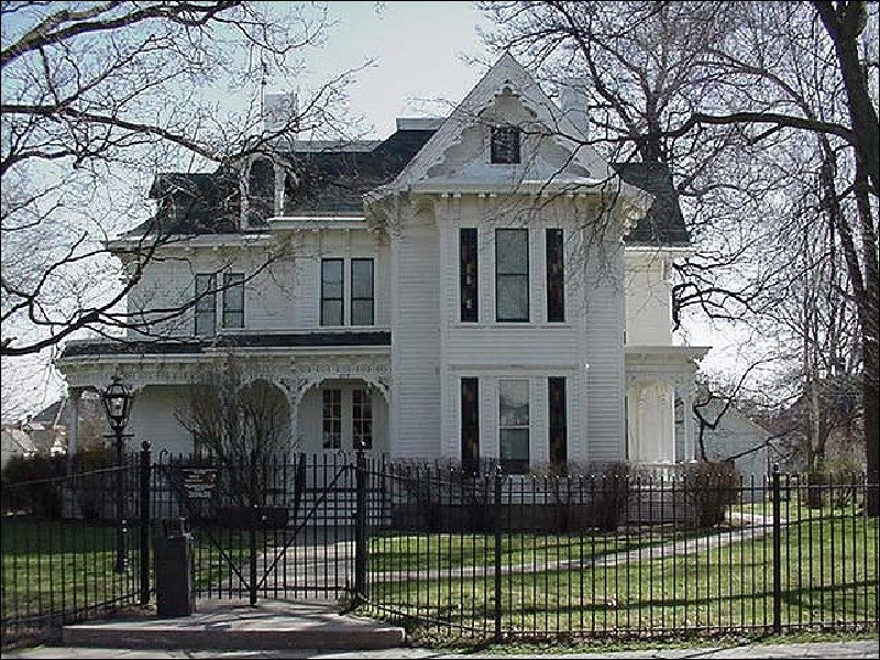 Photo of a large, two-story white house.