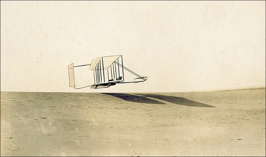 Photo of Orville Wright flying the 1902 glider.