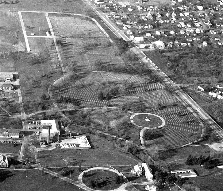 Aerial view of of a cemetery with monument in the middle.