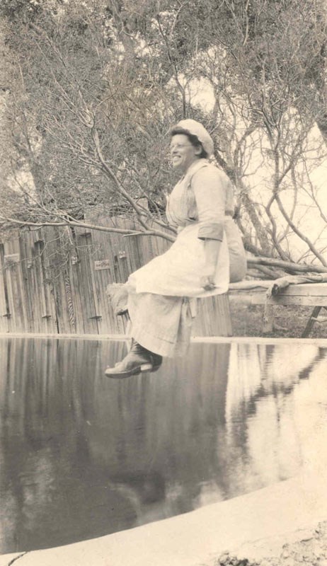 Woman sitting by the water.