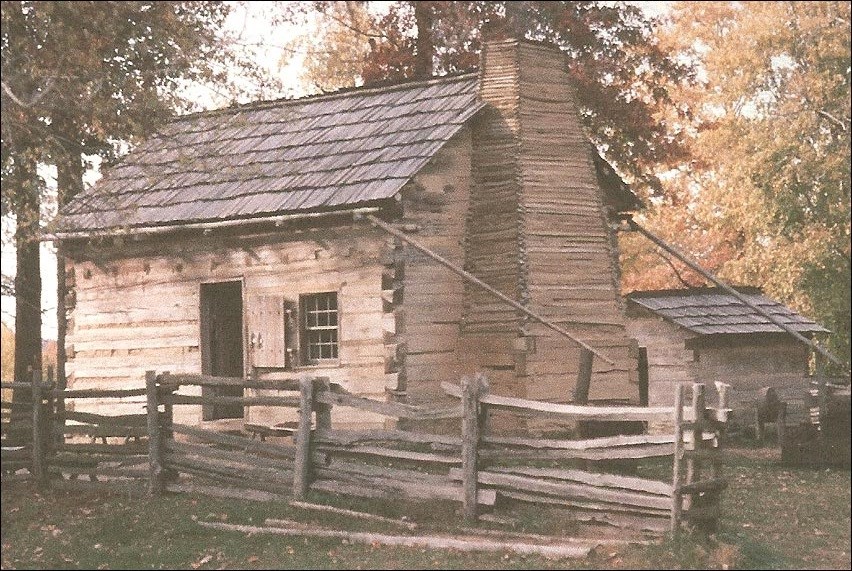 Log cabin surrounded by trees. national park Service.