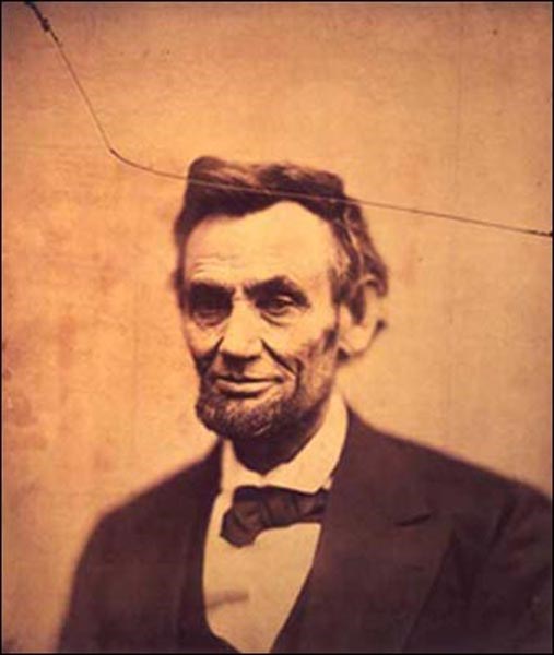 Photo of a slightly smiling Abraham Lincoln from the chest up.