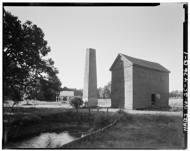 The rice barn and threshing mill at Mansfield Plantation, SC were common features of Georgetown County rice plantations. Library of Congress.