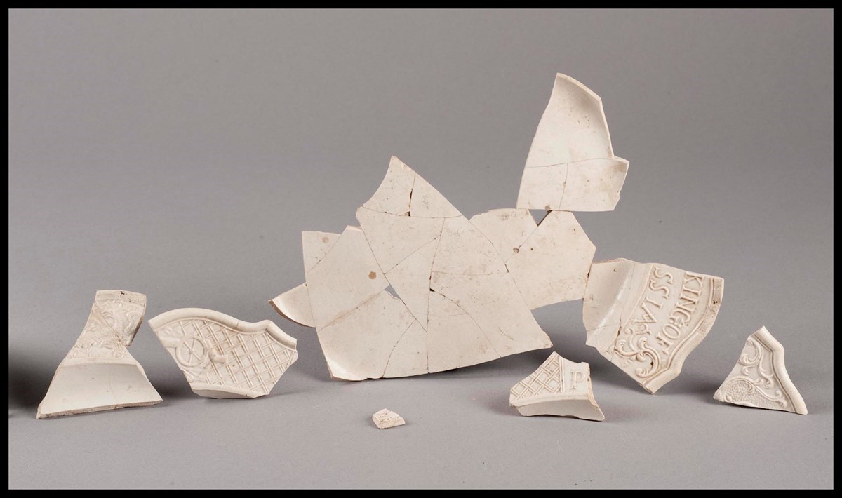 A line of ceramic shards with molded detailing.