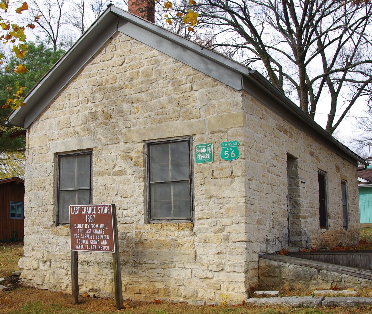 Small stone building surrounded by trees