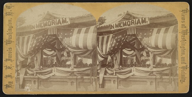 A bandstand is draped with decorative bunting.