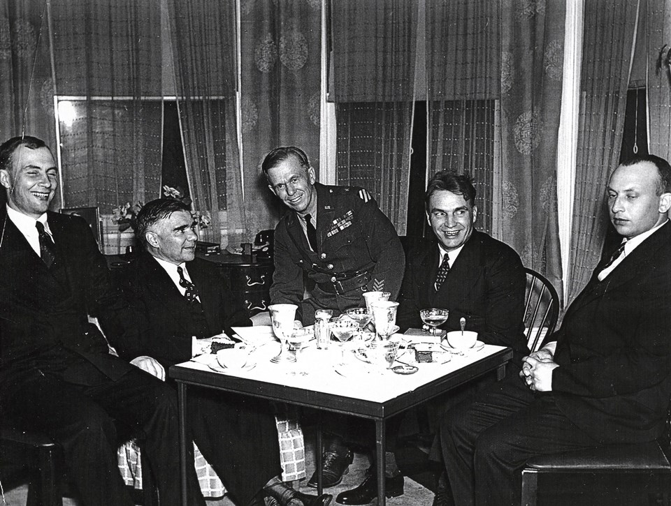 Photo of men seated at table