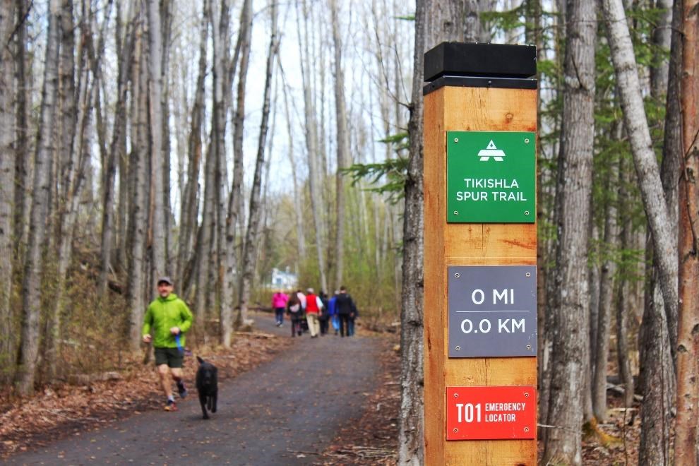 An Anchorage resident jogs with his dog on the Tikishla Spur Trail in Tikishla Park, which is included on the Catholic Social Services Wellness Map. Photo courtesy of Anchorage Park Foundation.