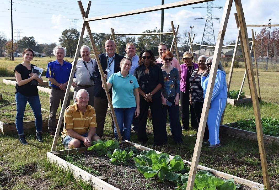 Liz Smith-Incer (center), a project specialist with the National Park Service – Rivers, Trails and Conservation Assistance program, and community stakeholders at a community garden in Mobile, Alabama. Groundwork Mobile County is the newest Trust in the Gr