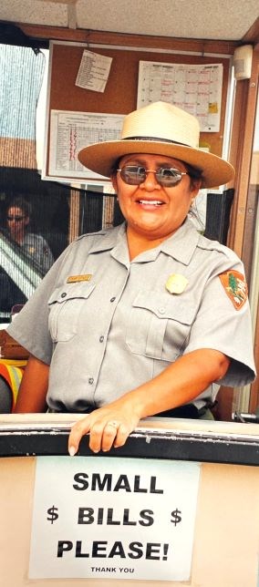 Mary Little Park Story (2) Park Ranger smiles, a sign reads small bills please.