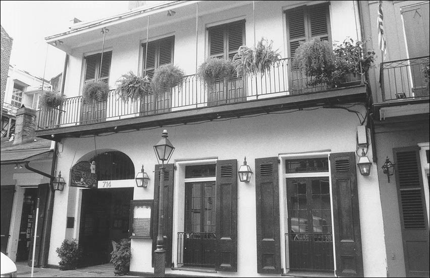 Exterior of two story building with terrace.