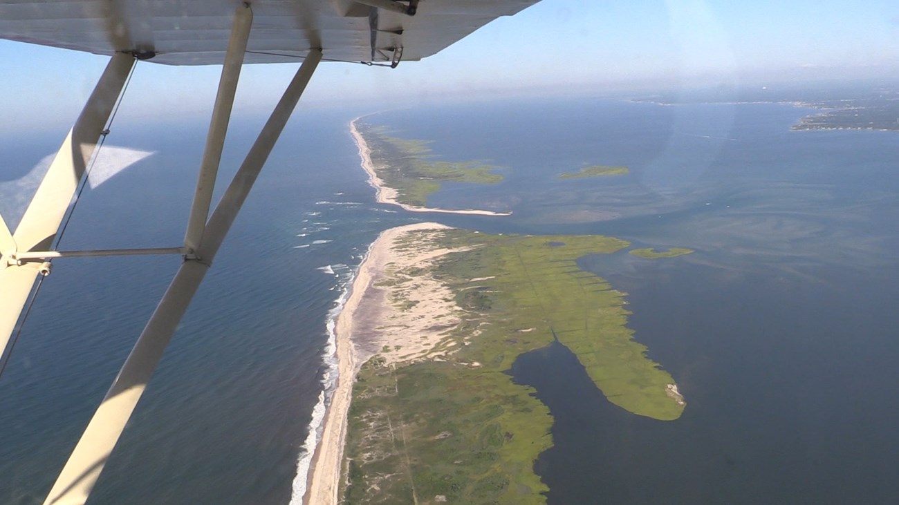 lt= An aerial view of the Fire Island breach looking down from a fixed wing plane