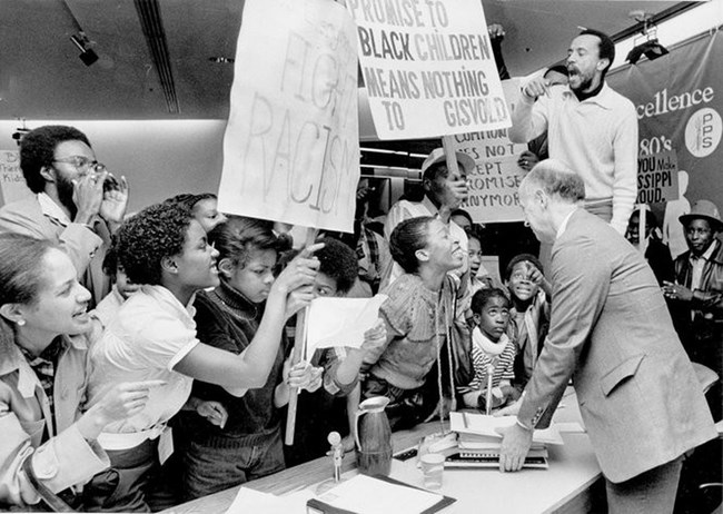 B & W image of students protesting a school closure