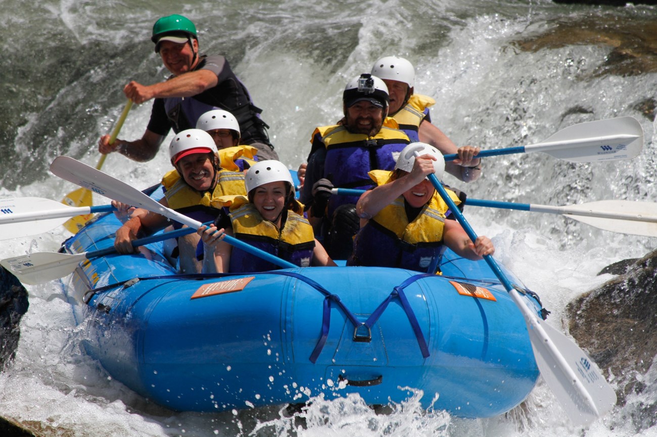 Rafters paddling through whitewater.