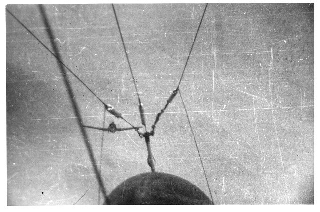 view of sky framed by cables on an airplane