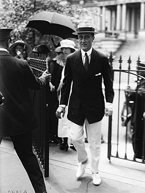 Franklin Roosevelt walks through a gate outside the War Department building.