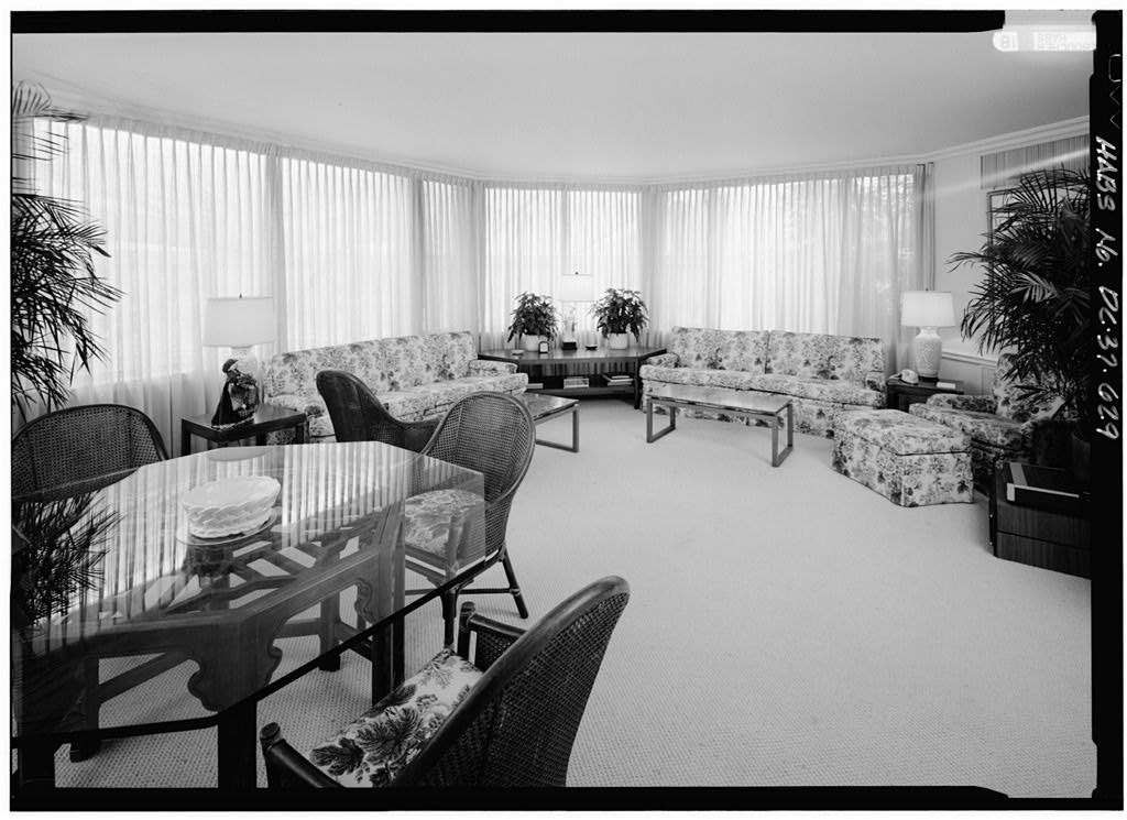 Large room with windows and 1960s furniture