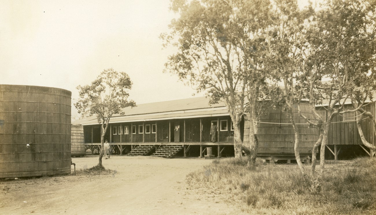 Black and white photo of an old building and water tank