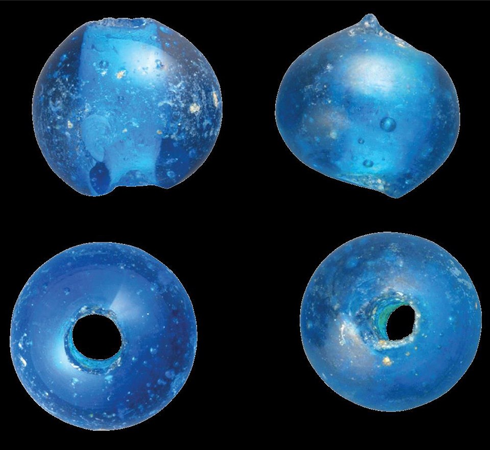 End and side views of two spherical blue beads.