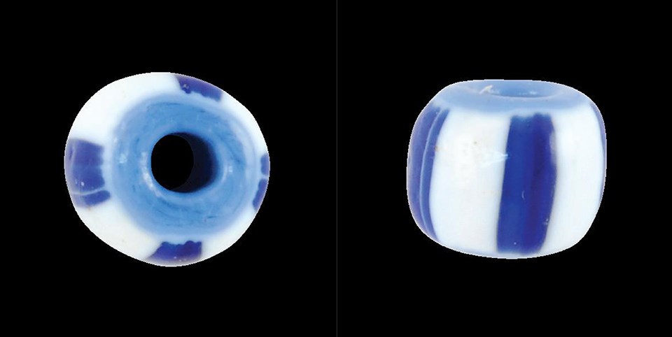 End and side views of a spherical bead, white with four blue stripes and a blue interior.