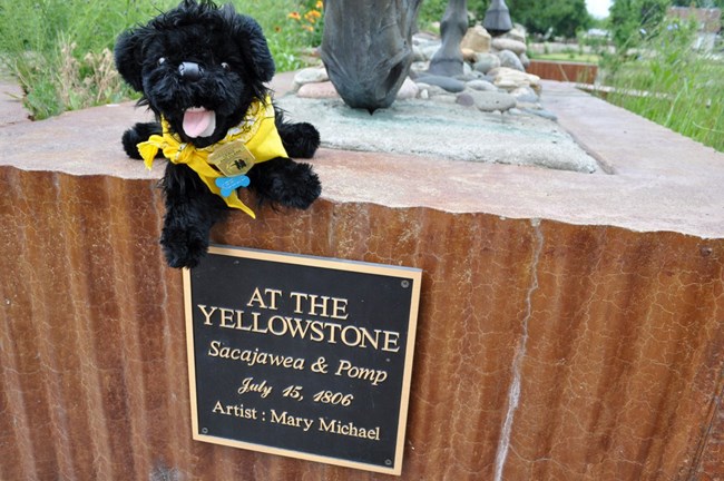 toy dog near statue