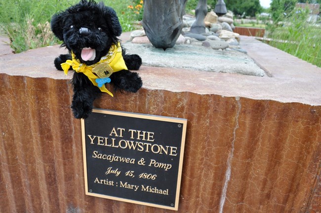 toy dog near statue