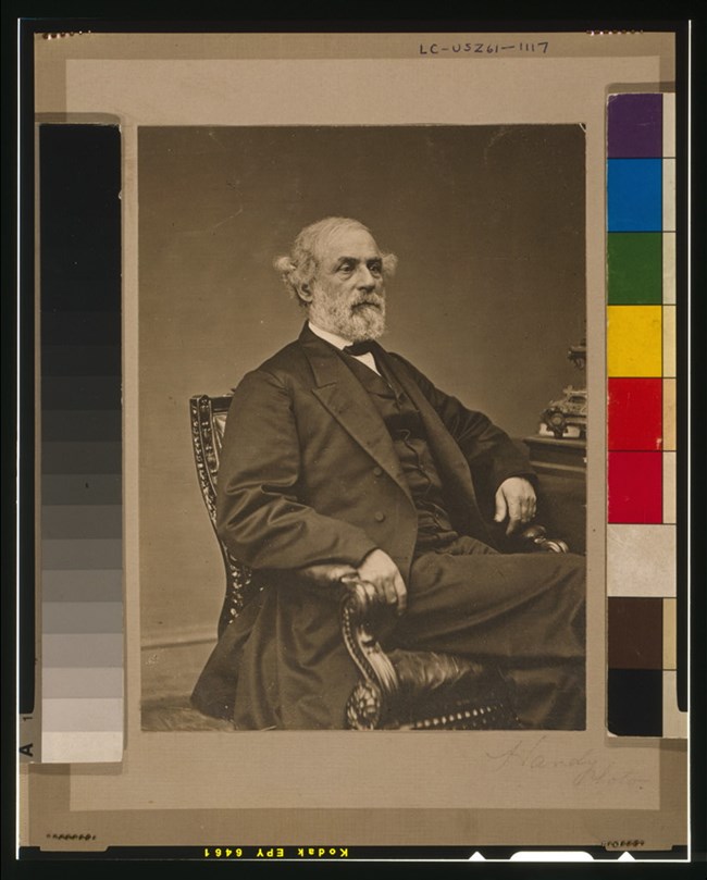 General Robert E. Lee is pictured in a chair facing right.