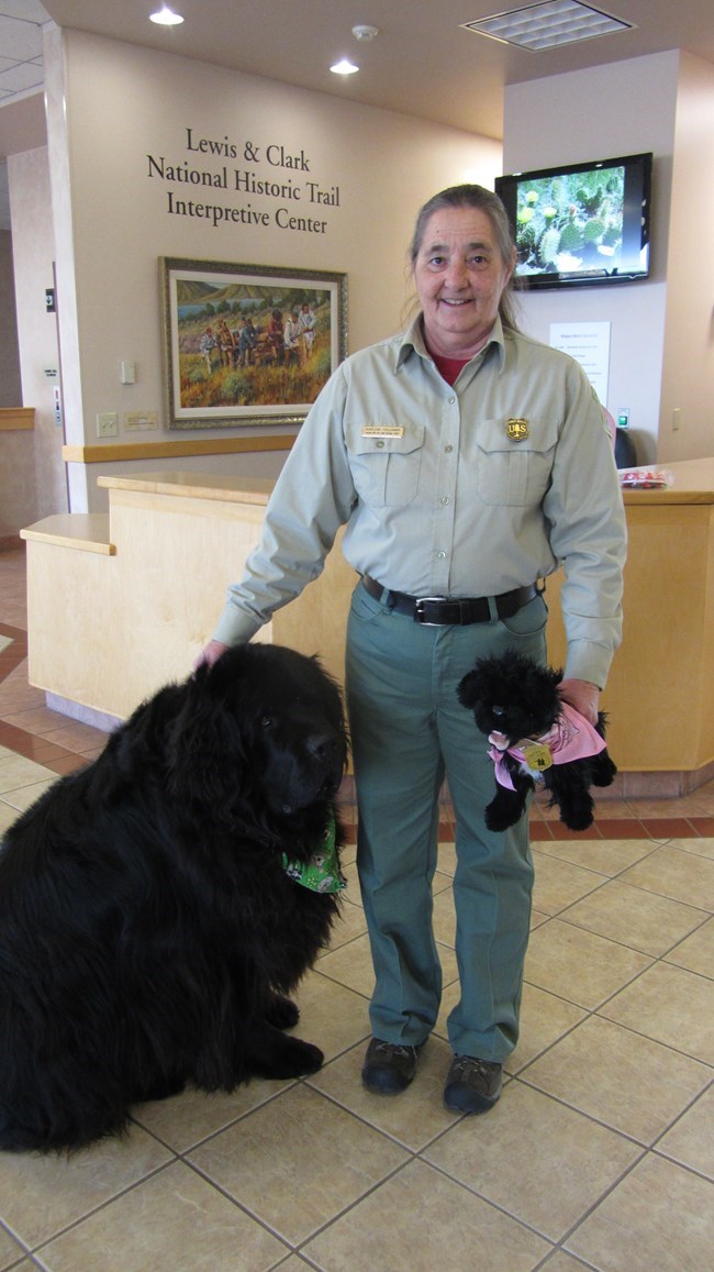 Volunteer standing next to dog