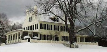 Large white house covered in snow.