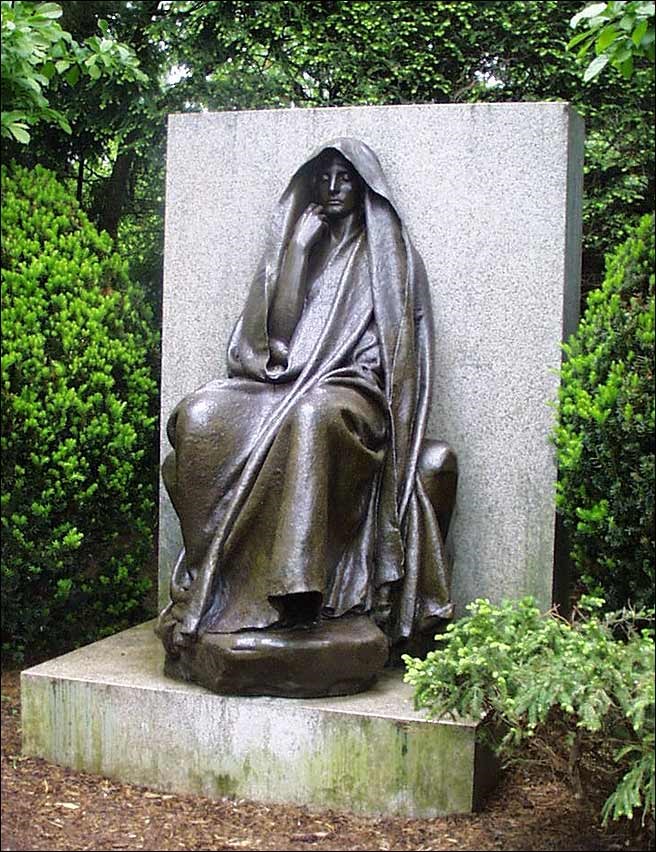 Statue of a woman wearing a cloak.