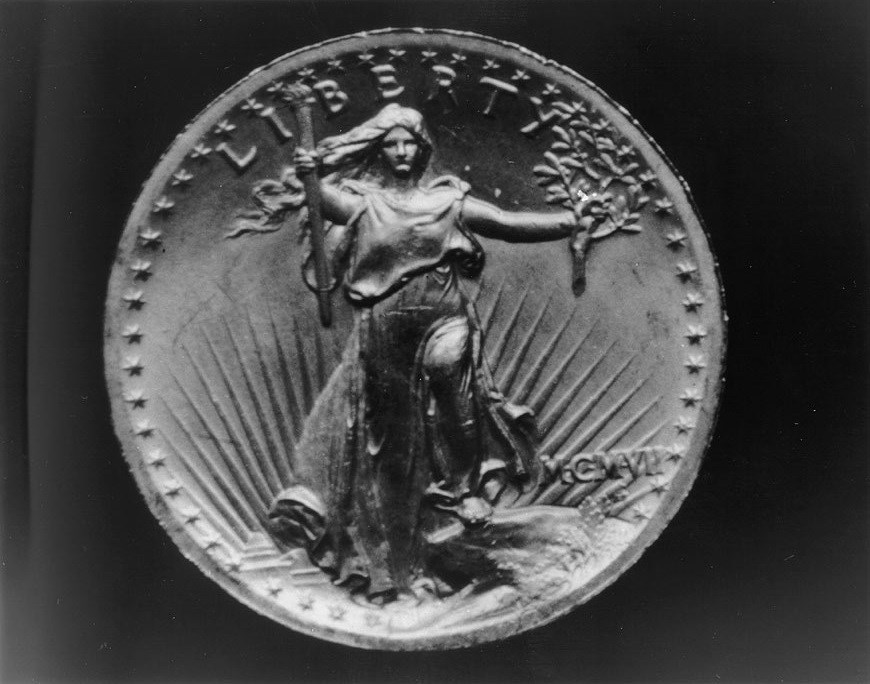 Image of a woman engraved on a coin.