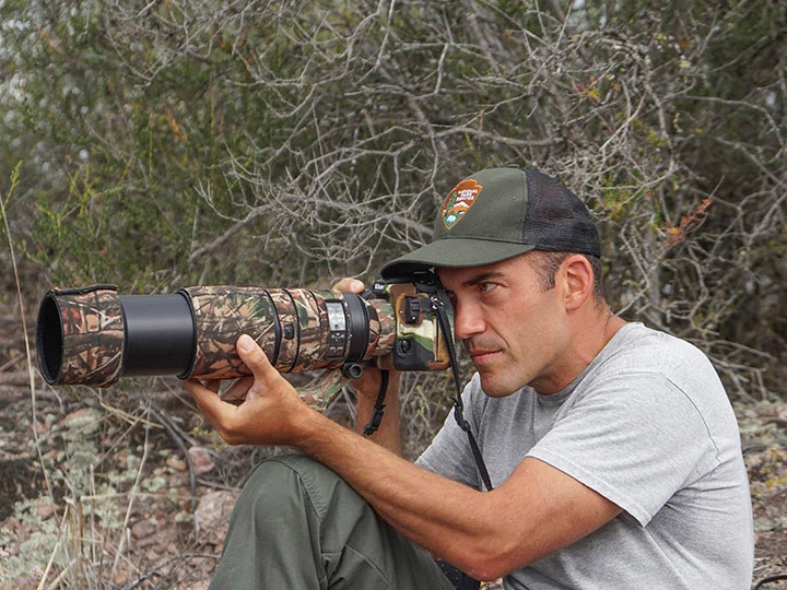 4_3xDSC01566 Biologist Gavin Emmons photographing prairie falcon nestlings with a telephoto lens.