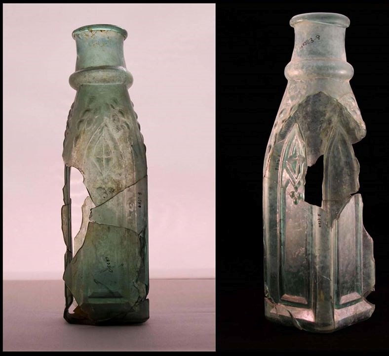 Front and back of a cloudy, cracked, glass pickle bottle.