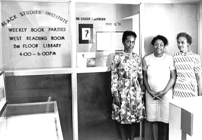B & W image of women in front of the Black Studies archive