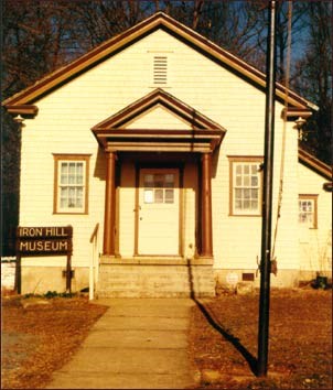 Small one room school house with two windows and a door.  (Susan Brizzolara Wojcik)