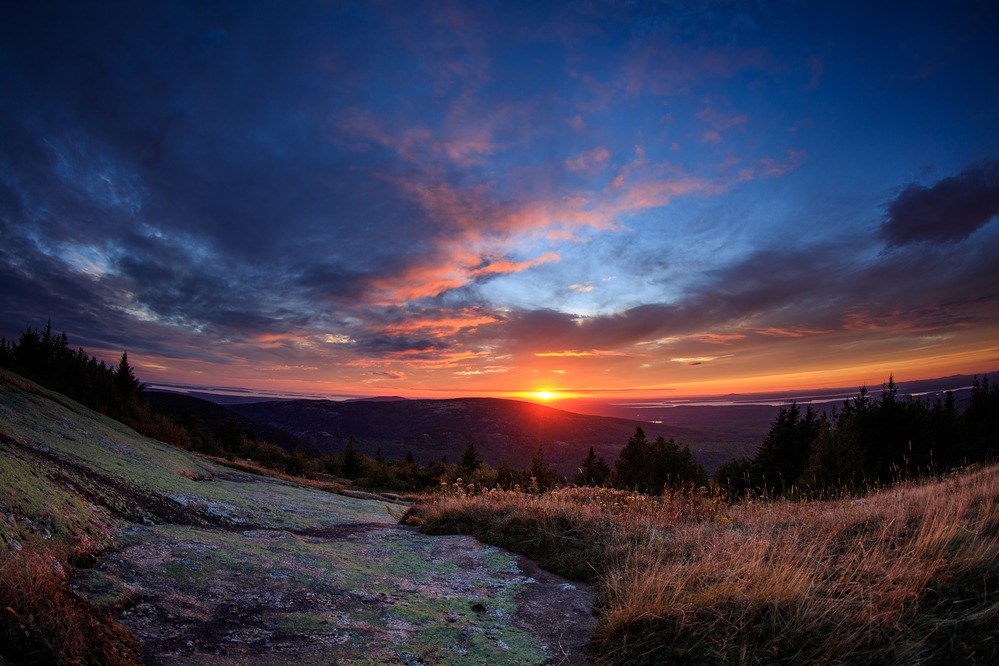 Vivid blue and orange sunset as seen from Cadillac Mountain