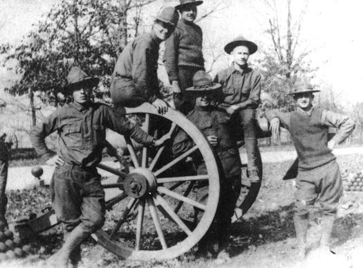 WWI Soldiers from Camp Colt pose on a battlefield gun.