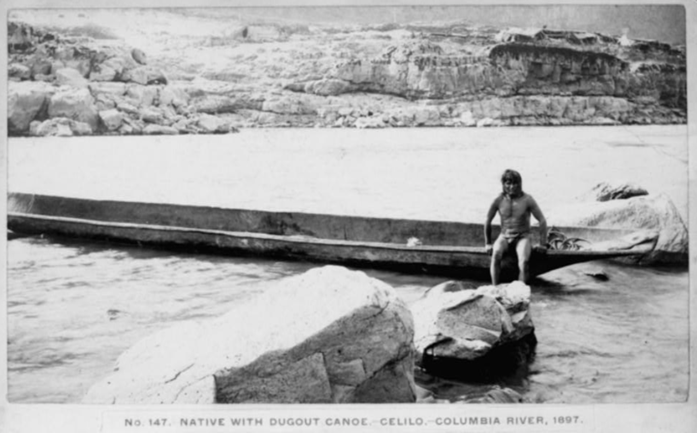 Native man in canoe on Columbia River