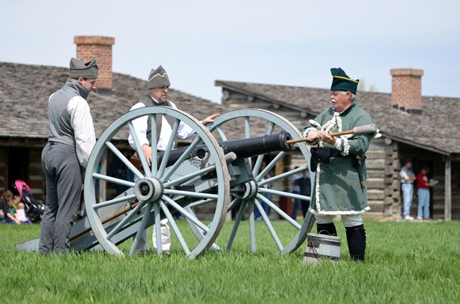 Three men near cannon