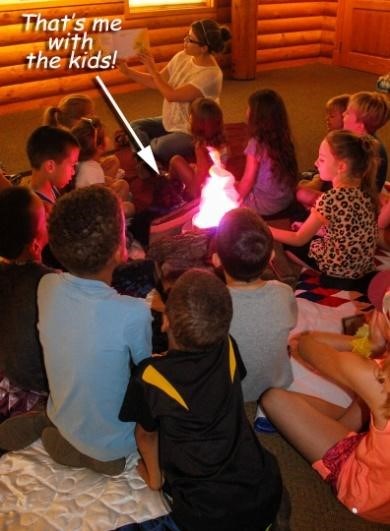toy dog sits with kids at Campfire Stories