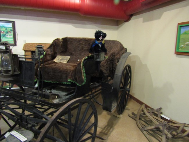 Stuffed pup on old buggy