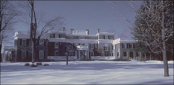 Large brick house covered  in snow.