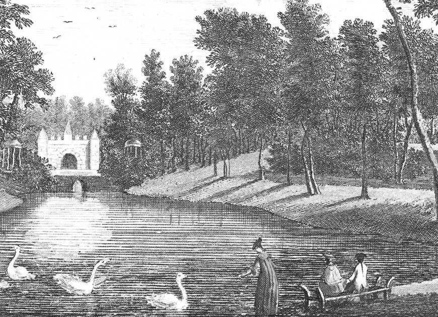 Women sitting on bench by pond.