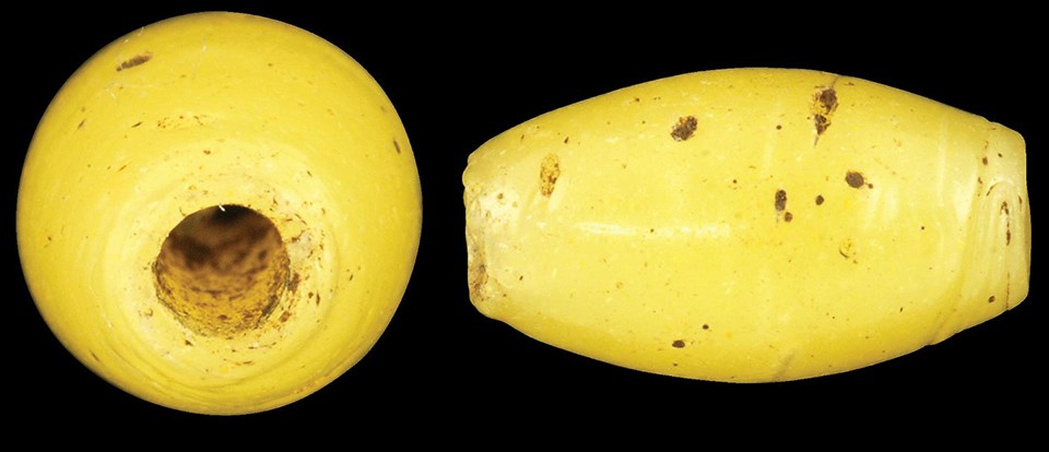 End and side view of a bright yellow bead.