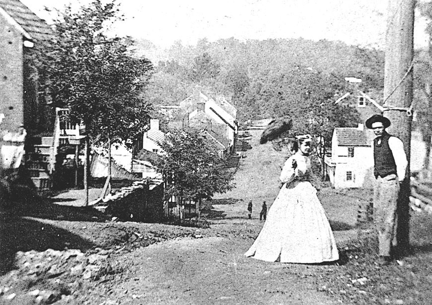Black and white photo of man and woman standing in dirt road. Black and white photo of man and woman standing in dirt road.